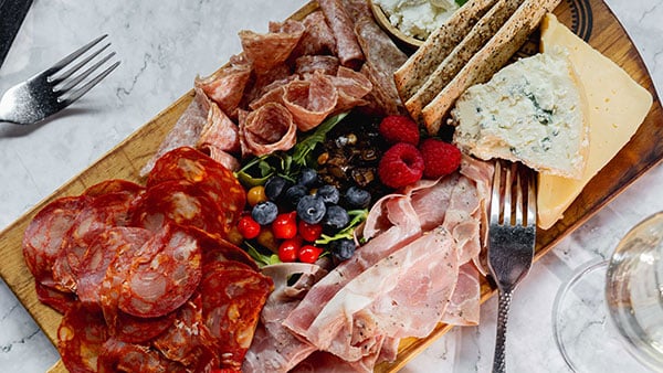 Artisan charcuterie board with cured meats, cheeses, berries, and crackers served at The Bistro at Gervasi Vineyard.