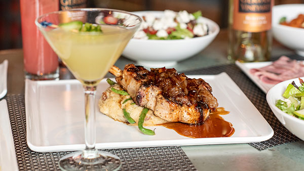 Gourmet entrée with caramelized onions and mashed potatoes served with craft cocktail and fresh salads at Gervasi Vineyard