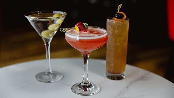 Gervasi Spirits Small Batch Vodka with a dry martini garnished with olives, set against a bright yellow background for a bold visual statement