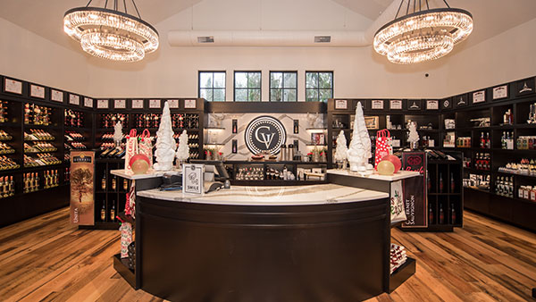 Festively decorated Gervasi Vineyard Marketplace featuring chandeliers, holiday trees, and gift displays for seasonal shopping in Canton, Ohio.