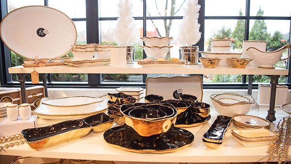 Pampa Bay luxury serveware display with black and gold holiday platters, bowls, and trays at The Marketplace at Gervasi Vineyard.