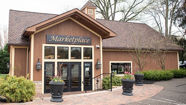 Exterior entrance of The Marketplace at Gervasi Vineyard, a charming boutique gift shop with seasonal decor and wine-themed gifts.