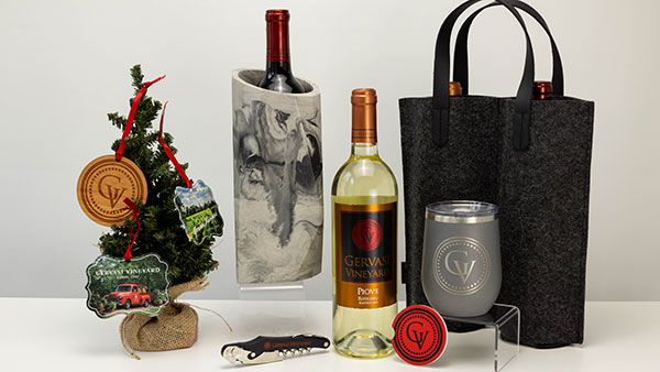 Holiday gift selection from The Marketplace at Gervasi Vineyard showcasing Piove wine, wine accessories, branded tumblers, ornaments, and wine totes for seasonal giving.