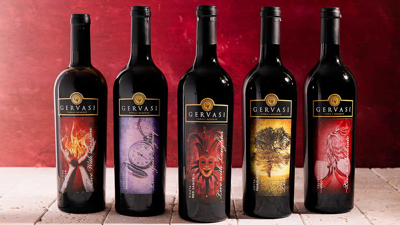 Five bottles of Gervasi Vineyard’s Family Reserve wine series displayed against a bold red background, showcasing award-winning estate varietals.