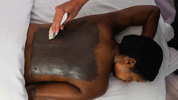 Guest receives a detoxifying body wrap treatment at The Spa at Gervasi Vineyard, highlighting premium wellness experiences and personalized spa services.