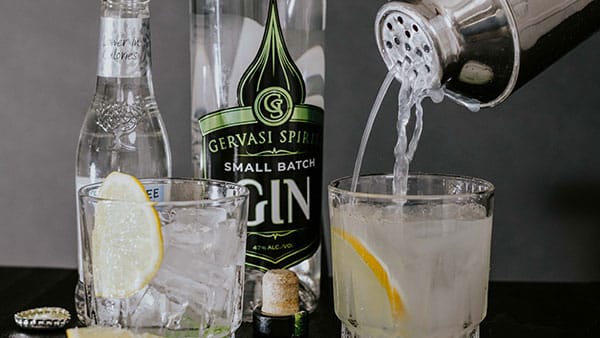 Cocktail being poured into a glass with lemon slices using Gervasi Spirits Small Batch Gin and tonic