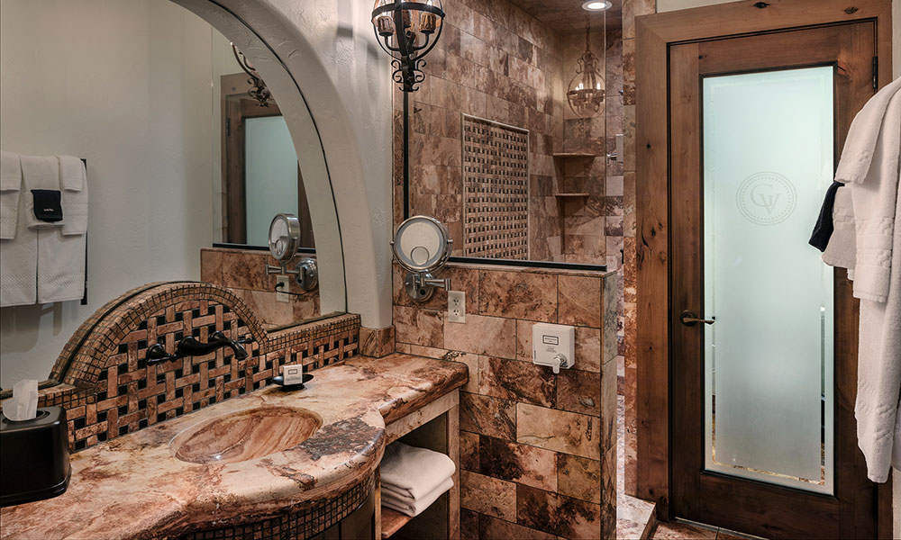 Villa bathroom at Gervasi Vineyard showcasing marble countertops, tiled shower, and Tuscan-style finishes with premium amenities