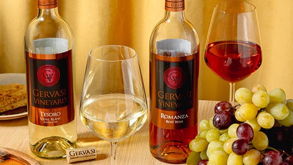 Gervasi Vineyard Tesoro and Romanza wines with glasses and grapes displayed for fall wine pairing.
